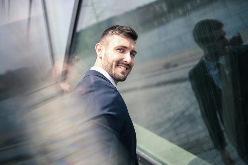 Man Smiling in Front of Window