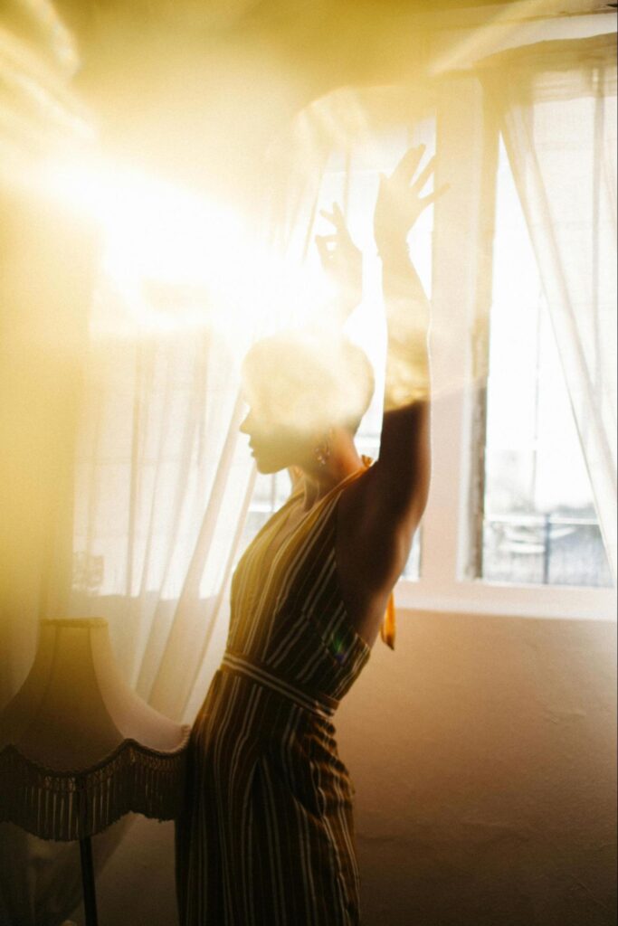 Woman Standing in Window Light