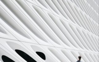 Modern Building with Man Walking Next to it