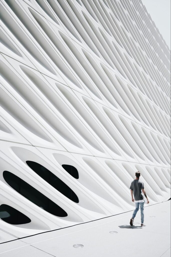 Modern Building with Man Walking Next to it