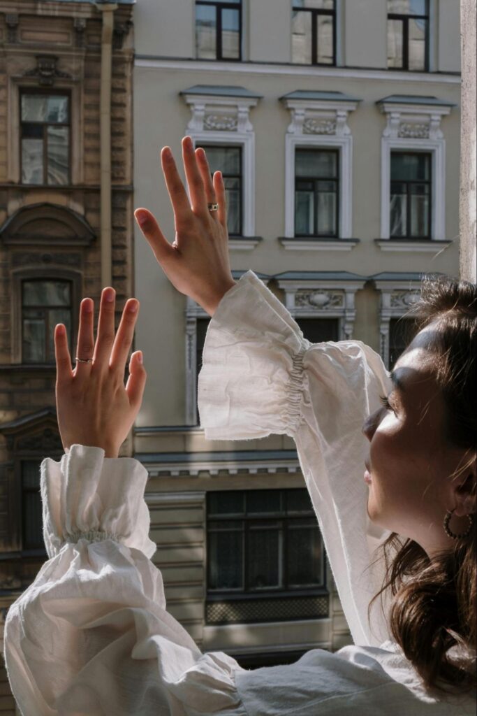 Woman With Arms up at Window 