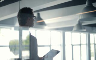 Man Standing Near Office Windows